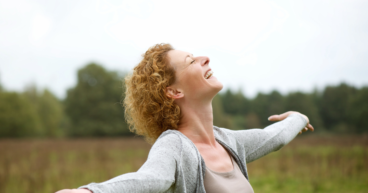 woman with outstretched arms, happy