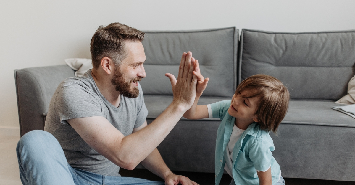 man and child playing