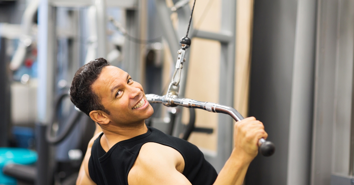 physically fit man working on his muscles in a gym