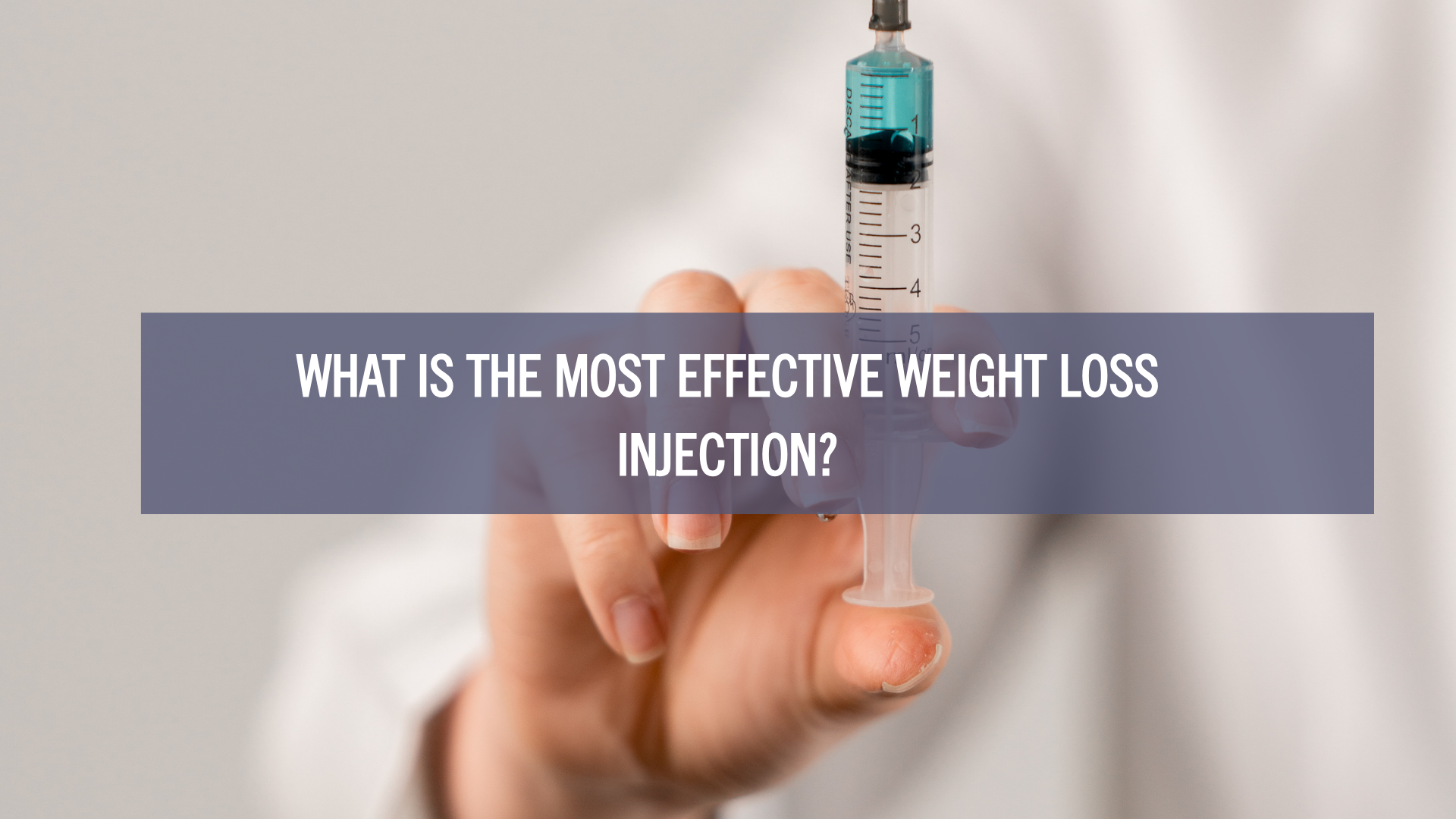 What Is the Most Effective Weight Loss Injection? Close-up of a hand holding a syringe filled with medication, representing medical weight loss treatments and injectable options.