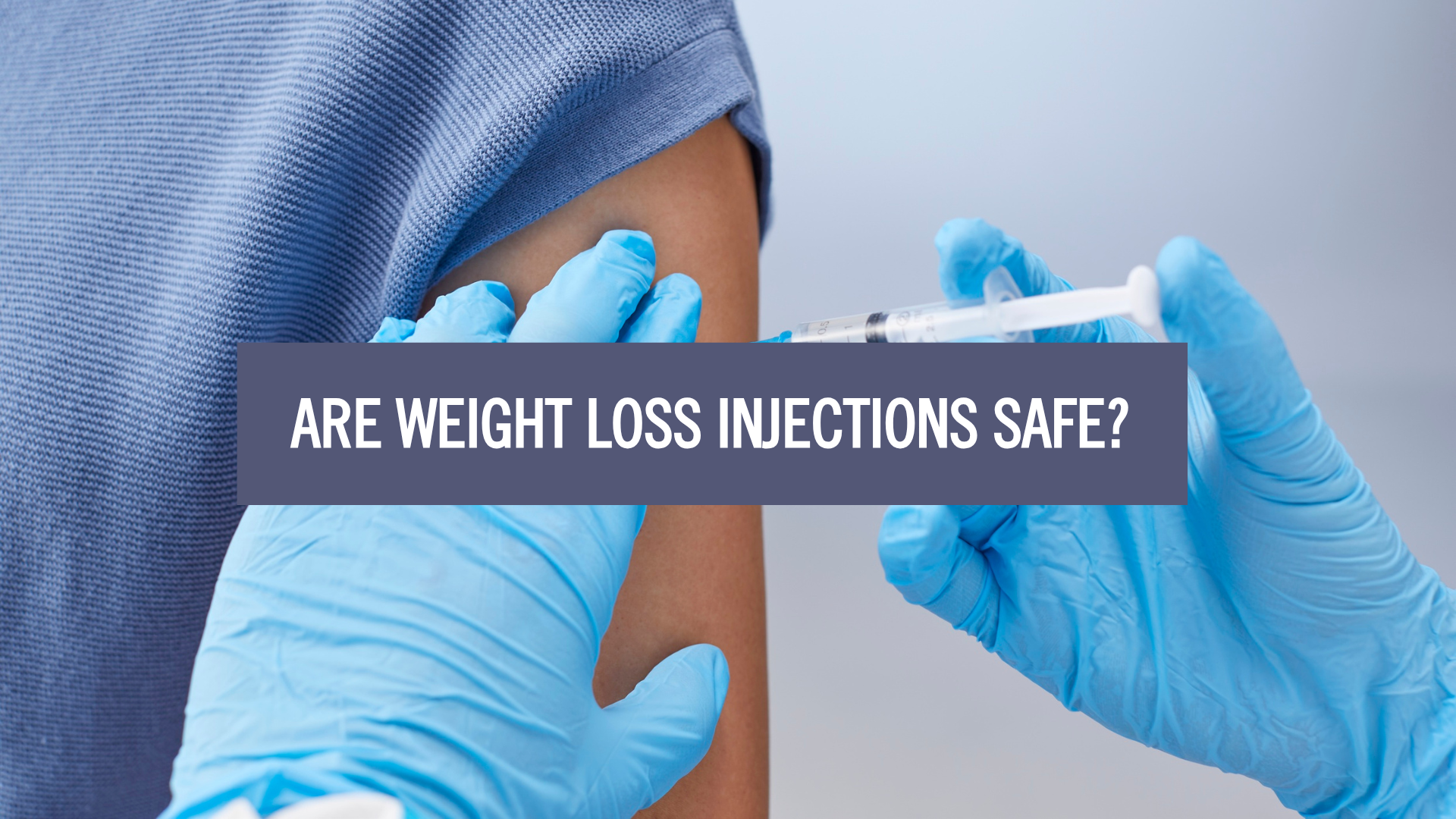 Are Weight Loss Injections Safe? Close-up of a healthcare professional wearing blue gloves administering an injection into a patient’s upper arm, illustrating medically supervised weight loss treatment.